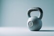 © haidar - Minimalist kettlebell resting on smooth surface,