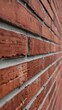 © Hitesh - Exterior Architectural Texture Detail Showing a Classic Red Brick Wall With Gray Joints Strong Perspective and Rough Urban Surface