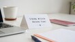 © Finasulizi - Elegant desk setup featuring a motivational sign that emphasizes teamwork and mission clarity in a modern office environment with minimalist accessories