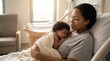 © Creative Concepts  - Mother holding her cute newborn baby wrapped in a blanket in hospital