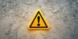 © Yevheniiya - Yellow warning sign with exclamation mark on a textured concrete wall background