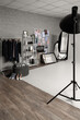 © Pixel-Shot - Interior of photo studio with shelf unit, clothes rack and pin board