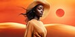 © NovaVision - Elegant woman in straw hat posing in desert landscape with sun setting