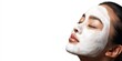 © NovaVision - Close-up of an Asian woman's face with a white facial mask applied, eyes closed