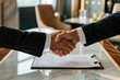 © aviavlad - Business partnership agreement shapes future in modern office