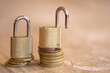 © sal - Brass Padlocks on Euro Coins Stack for Financial Security Concept