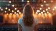 © easybanana - Woman Waiting Dimly Lit Auditorium with Bokeh Lights