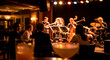 © Premium Visuals - Audience enjoying a live jazz band performance in a dimly lit, intimate club with drinks on tables, creating a relaxed mood.