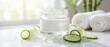 © Aurora Aesthetics - summer luxury skincare cucumber spa cream towel closeup wellness beauty with glass jar and fresh slices suggesting cooling hydration clean body care and premium resort treatment ritual