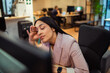 © Davor - Tired businesswoman rubbing eyes at computer in office