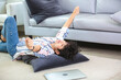 © chokniti - Relaxed woman casual home living room joyful mood comfortable clothing lying floor modern sofa indoor lifestyle leisure time laptop computer carpet young adult woman enjoys relaxed home comfort