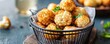 © Photo18@desing - Appetizing close-up Crispy golden fried cauliflower florets in a black wire basket, garnished with parsley. Delicious vegetarian snack. ,fried veggie ,appetizer