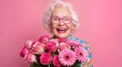 © ChaoticDesignStudio - Cheerful elderly woman holding bouquet of pink flowers against pink background. Mature lady with white hair and stylish glasses celebrating special occasion.