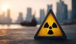 © Mimi - A triangular radioactive hazard symbol stands prominently on a concrete pier against a hazy urban skyline at sunset with warm orange tones in the sky