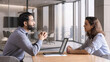 © insta_photos - Indian male hr specialist manager, employer, boss listening female latin candidate at job interview, consulting client at office meeting. Hiring and employment, human resources, recruitment concept.