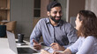 © insta_photos - Two professionals - happy smiling indian hr manager and latin young female colleague at office meeting having fun. Mentoring Hispanic male teacher and female student in multiethnic creative space.