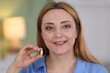© New Africa - Menopause, hormone replacement therapy. Woman holding pill at home