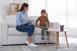 © New Africa - Professional psychologist working with little girl on sofa indoors