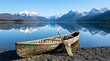 © Buhan - An Old Canoe Resting on a Rocky Shore Beside a Serene Lake with Snow-Capped Mountains Reflected in the Water
