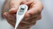 © DeryXin - Close-up of a hand holding a thermometer, medical healthcare photography