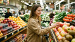 © FrameFlow - Young woman selecting fresh apples, grocery store produce department with fruit displays, shopper reaching for fruit, supermarket interior, retail and lifestyle