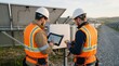 © Alex - Two technicians in safety gear inspecting solar panels with tablet and multimeter, renewable energy maintenance, green power infrastructure, sustainable technology concept.