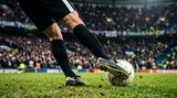 Low angle action shot capturing the dynamic movement of a soccer player's legs dribbling and striking the ball on the field during an intense game.