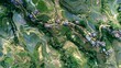 © Thuyet - aerial view of terraced rice fields and scattered rural homes as the main subject + faint traces of movement embedded in agricultural patterns suggesting passage of time and journey + diffused dayligh