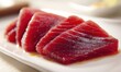 © TheoTheWizard - Sliced raw tuna with rich red hue and marbled texture on white plate