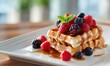 © TheoTheWizard - Delicious waffles with assorted berries, mint, and syrup on white plate