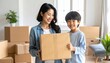 © DSR - Happy Asian mother and son moving into new home.