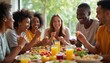 © Vadym - Diverse group of friends laughing while sharing meal at table. People enjoy food, conversation, togetherness, good vibes. Casual indoor gathering with healthy snacks and drinks.