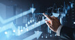 © ImageFlow - Business hand interacting with rising financial graphs and glowing market indicators showing growth trend on futuristic blue digital background.