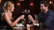 © makedonski2015 - Couple toasting wine glasses during dinner at restaurant