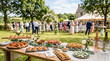 © val_webart - Outdoor catering setup with assorted dishes at wedding reception