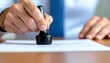 © Domurigu - Businessman stamping official document for agreement and approval