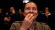 © benjamin - A movie enthusiast captivated by the cinematic experience, enjoys a tasty snack within the comfortable ambiance of the theatre.