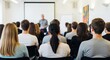 © twilight mist - Business professionals and students listen attentively to a speaker in a well-lit presentation room.