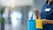 © Laura - Faceless cleaning lady holding a bucket of cleaning products on a softly defocused background for a professional service concept. Defocused background. Cleaning lady bucket,