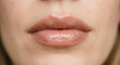 © amavcoffee - Macro close-up of lips with nude gloss