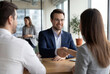 © Meow Creations - Professional man shaking hands with woman in office
