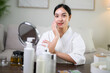 © PaeGAG - Asian woman applying makeup at home mirror, beauty and skincare routine lifestyle