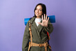 © luismolinero - Young mountaineer woman with a big backpack over isolated background counting five with fingers