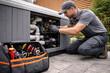 © hr-gold - Technician repairs hot tub equipment near outdoor residential property