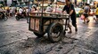 © Taras Yasinski - City street food culture, close-up of cart wheels on rough asphalt texture, street food cart, urban texture, unscripted local culture, city commerce