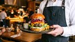 © Obbinokes - A professional chef in a white uniform proudly holding a tray with two delicious gourmet burgers with fresh ingredients. A high-quality visual for restaurant branding and food industry.