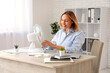 © Pixel-Shot - Beautiful mature happy businesswoman with electric fan in office