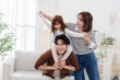 © charnsitr - Family sharing joyful moments together in living room