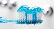 © mahrtgfx - Macro shot of blue gel toothpaste on a wet toothbrush covered in fresh water droplets