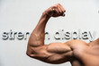 © Anastasiia - Subject: A muscular arm. Action: Displaying strength with a bicep curl. Setting: White background with text.